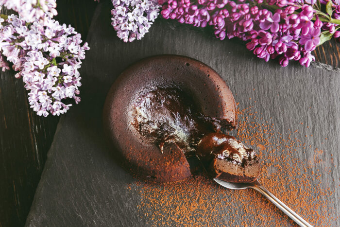 classic chocolate fondant on a dark background with flowers